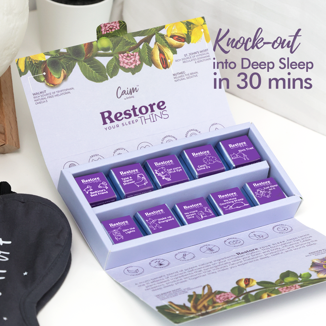 Box of 'Calm' sleep aid packets with a cup and eye mask on a white surface